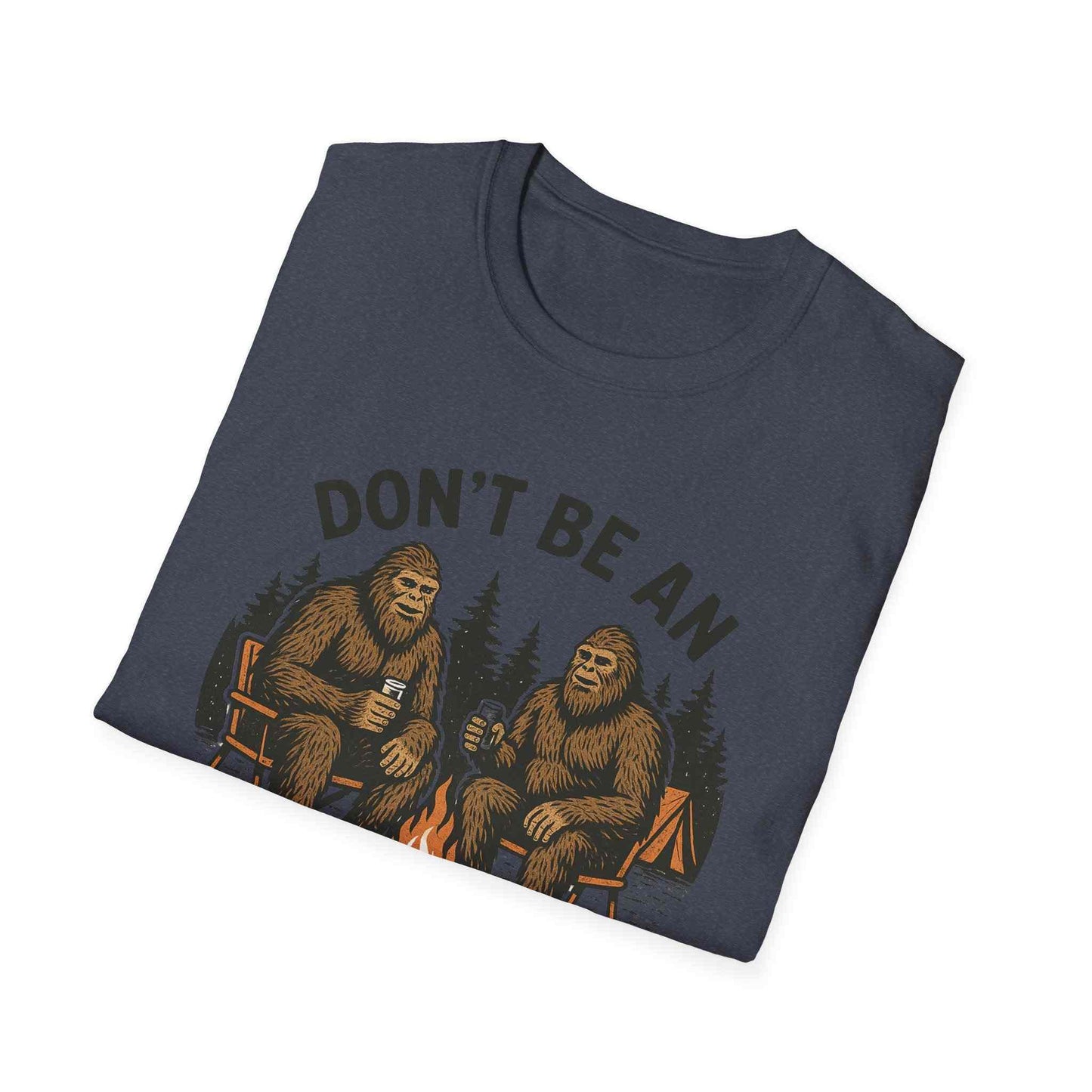 Funny Sasquatch Camping T-Shirt with Bigfoot design sitting by campfire on navy unisex tee