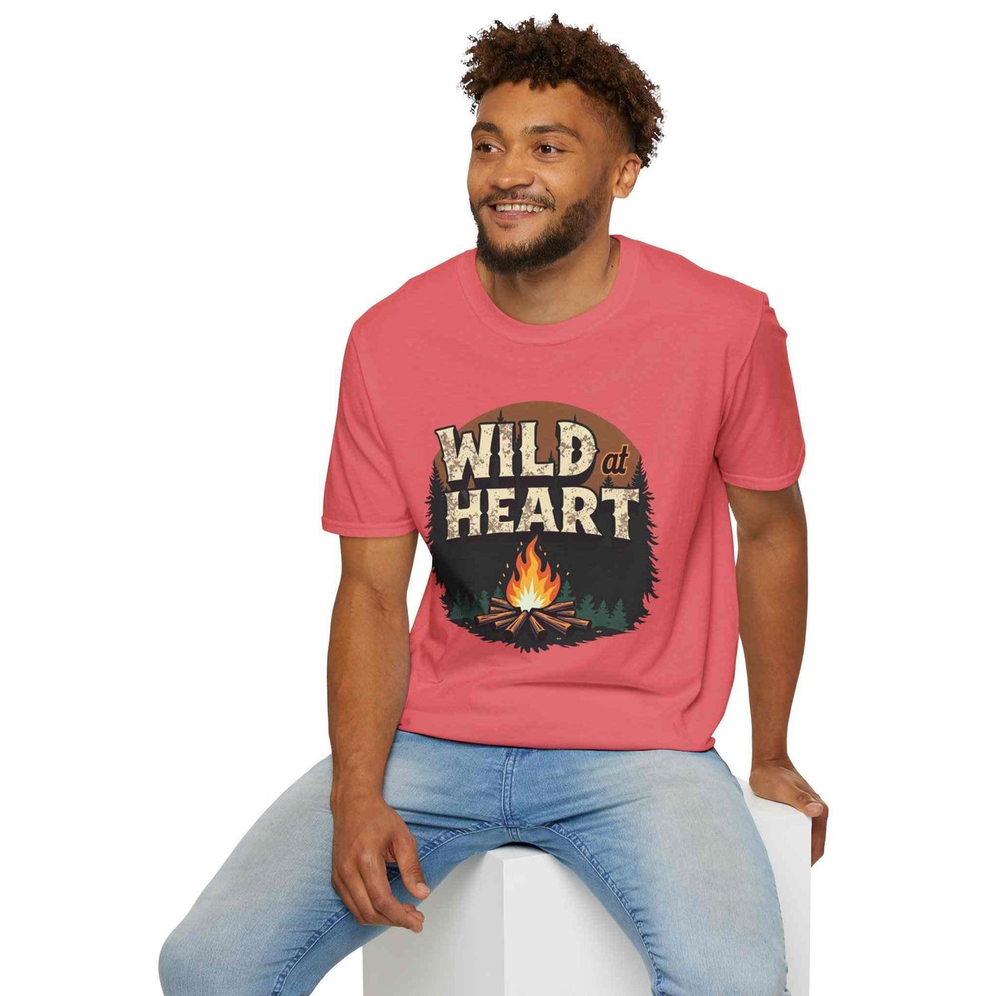 Man wearing red Wild at Heart Camping T-Shirt with campfire graphic sitting and smiling